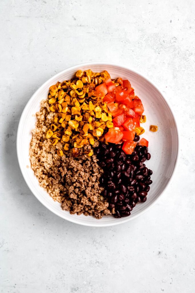 quinoa, ground beef, corn, tomatoes, and black beans on plate