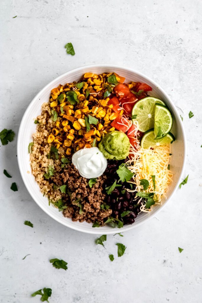 Quinoa taco bowl topped with cilantro and lime