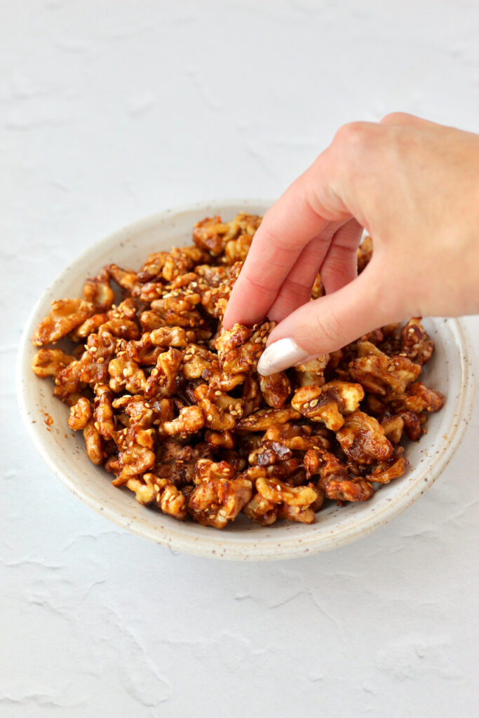 Picking up a walnut from bowl