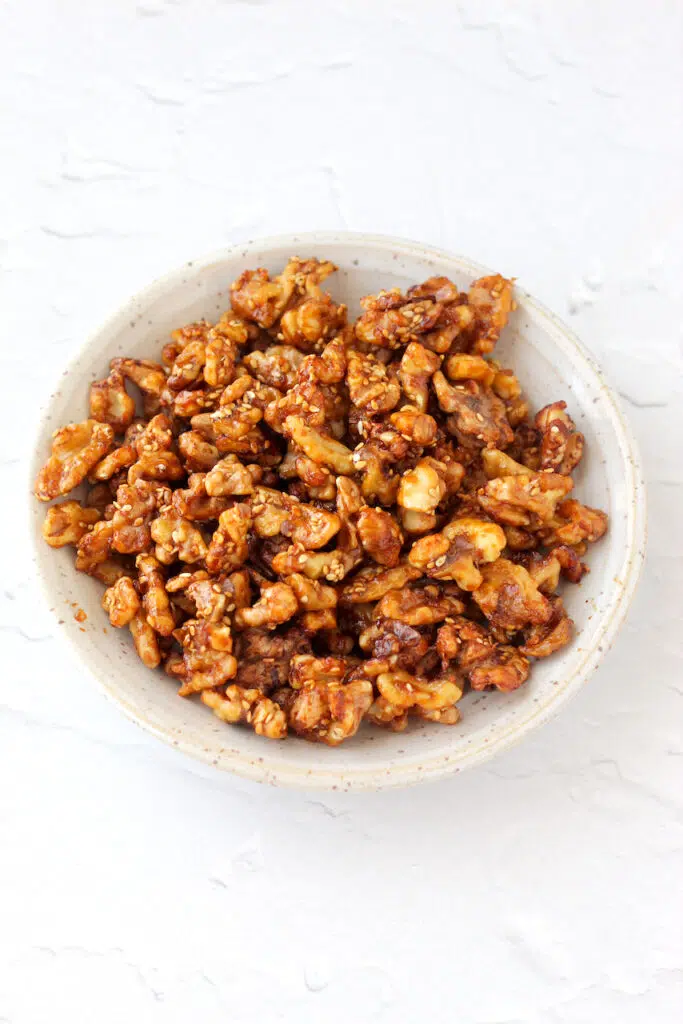 Close up of glazed walnuts with sesame seeds