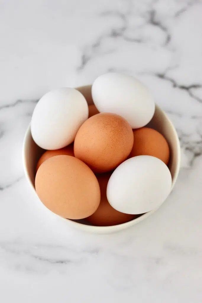 White and brown eggs in a bowl