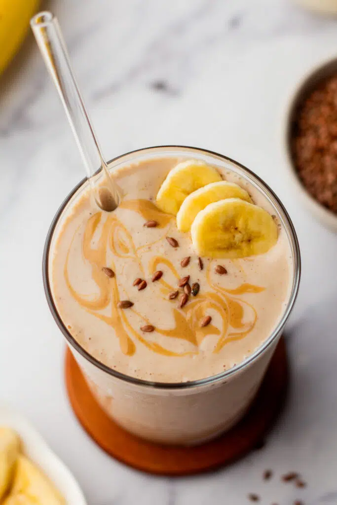 Flaxseed smoothie in a glass with banana and peanut butter, perfect for a healthy snack.