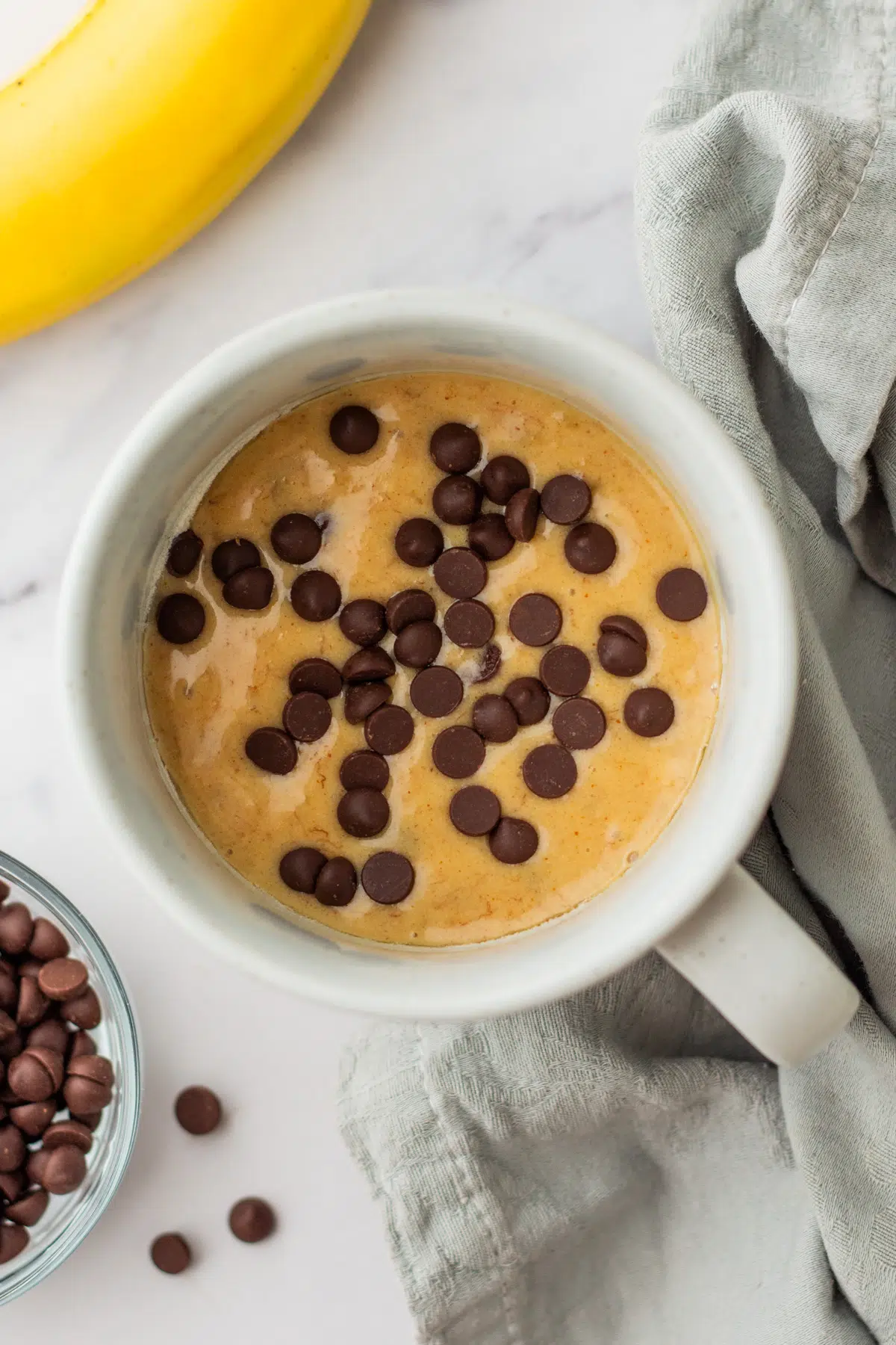 Chocolate chips on top of protein mug cake batter