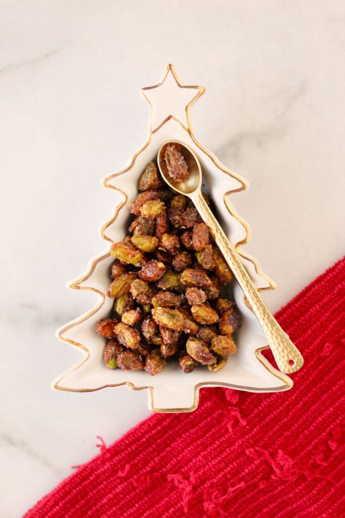 Christmas tree shaped bowl filled with honey roasted pistachios