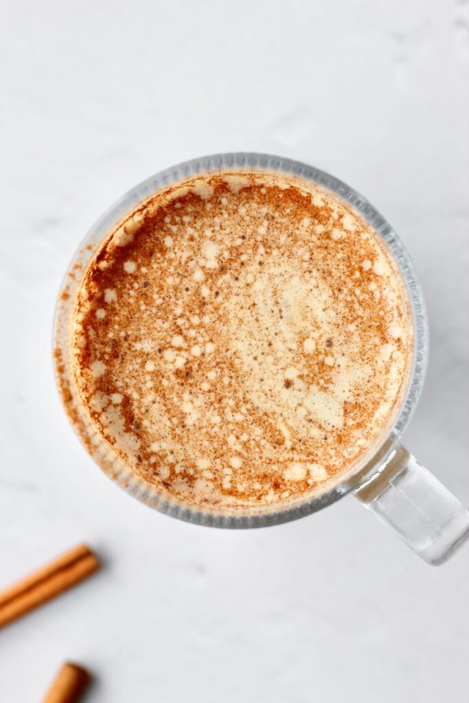 Cinnamon roll protein latte sprinkled with cinnamon