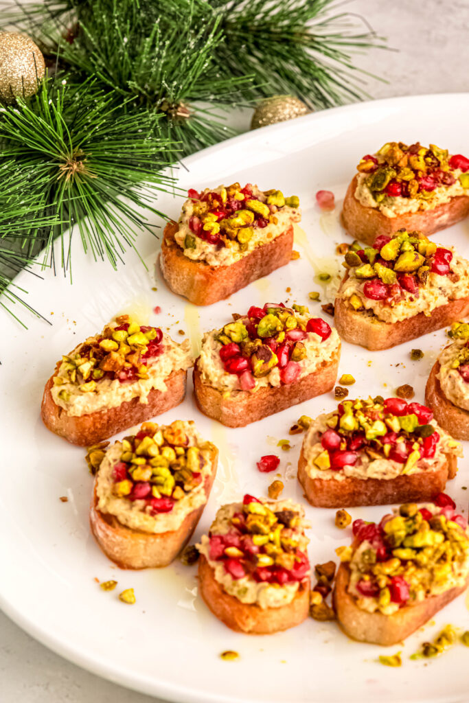 Pistachio and white bean crostini with pine tree in background