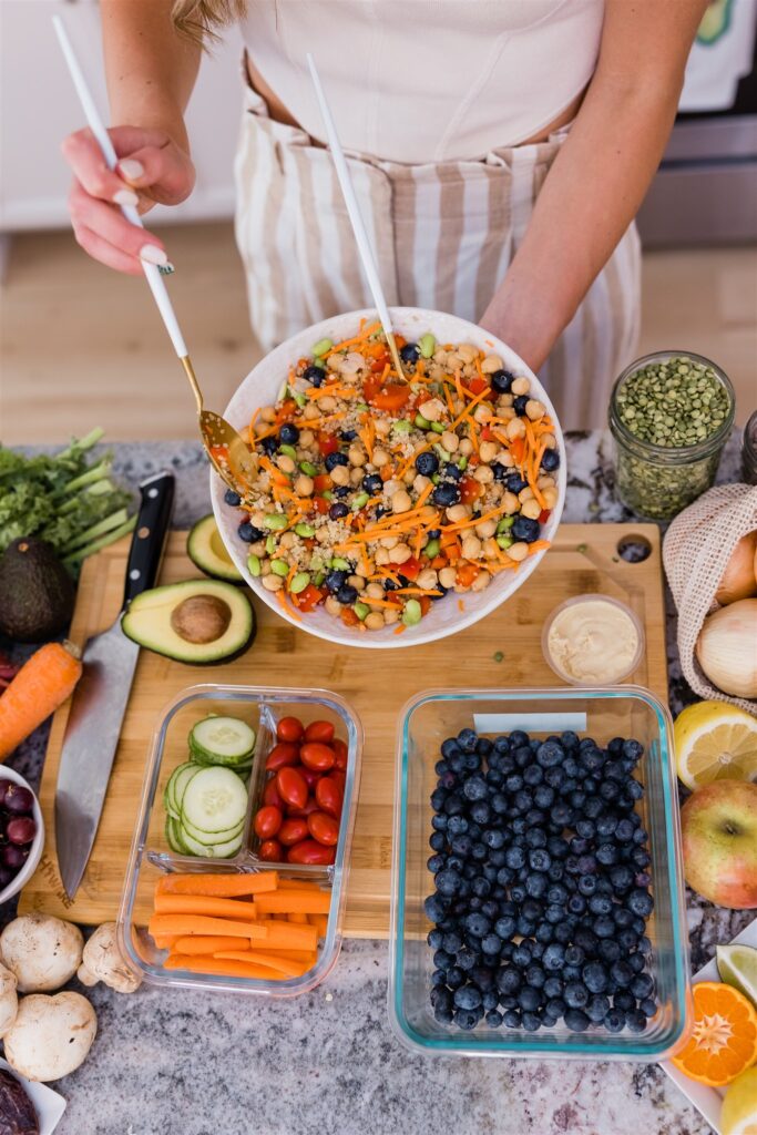 Variety of colorful foods surrounding chickpea salad