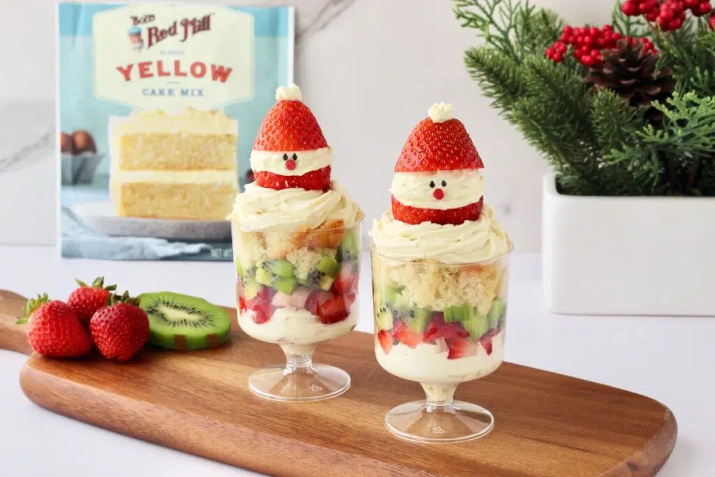 Individual Christmas Trifles on wood board with Bob's Red Mill yellow cake mix in background.