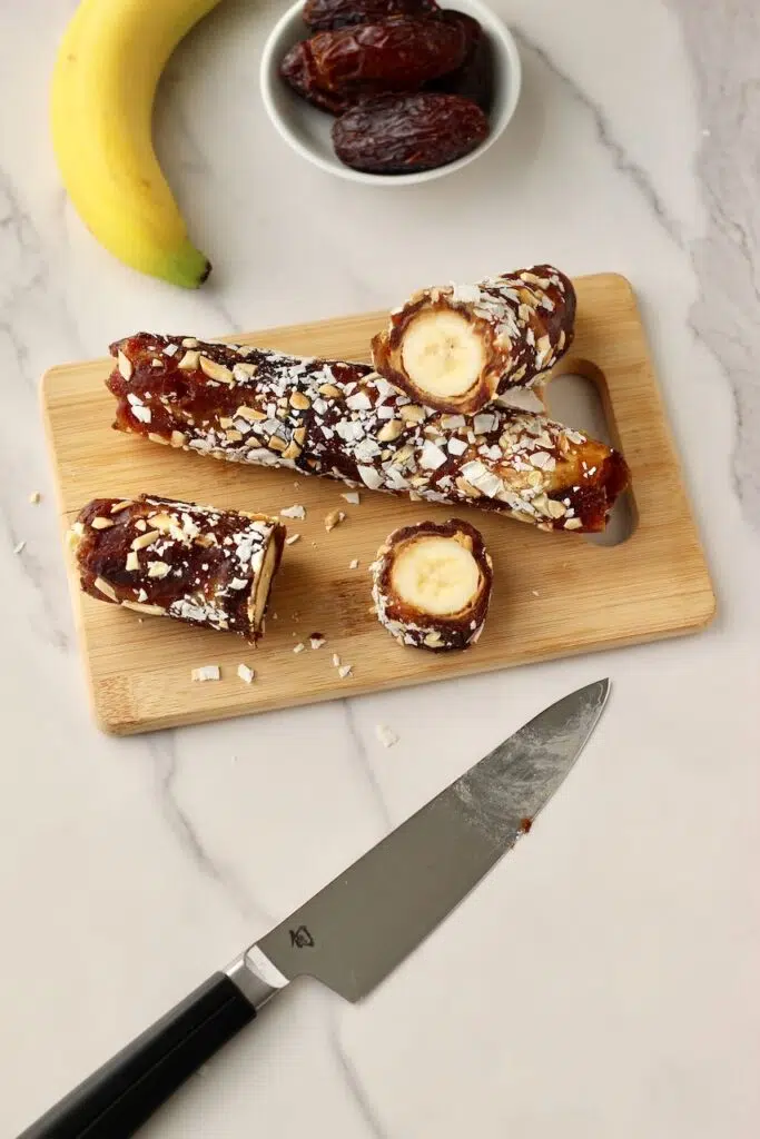 Cutting the rolled bananas into "sushi" slices