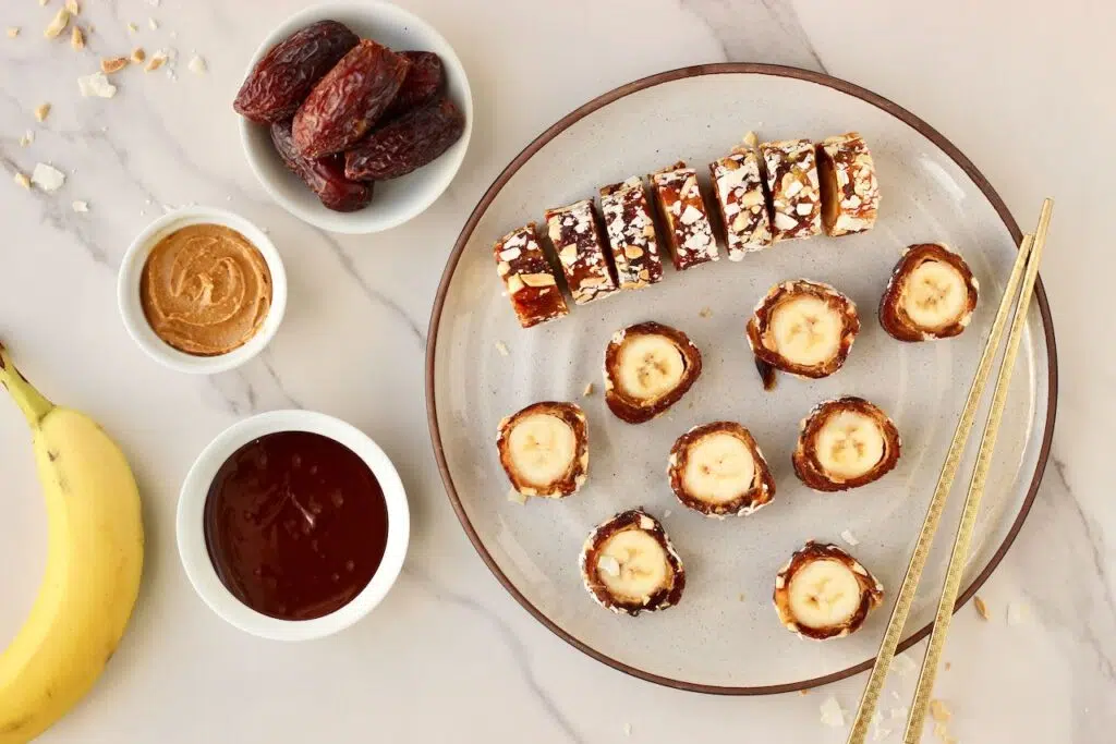 Banana sushi with Medjool dates, peanut butter and melted chocolate on the side.