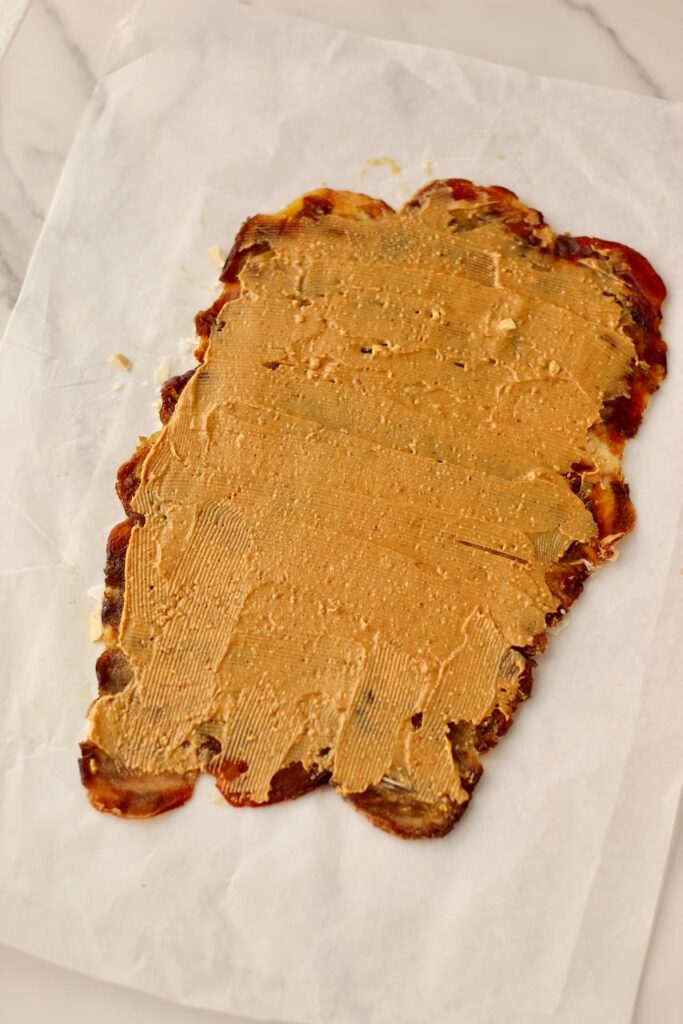 Peanut butter spread onto flattened Medjool dates