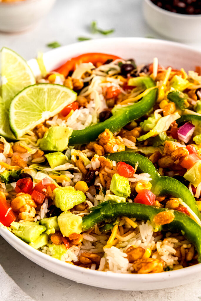 Tempeh burrito bowl close up with green peppers on top