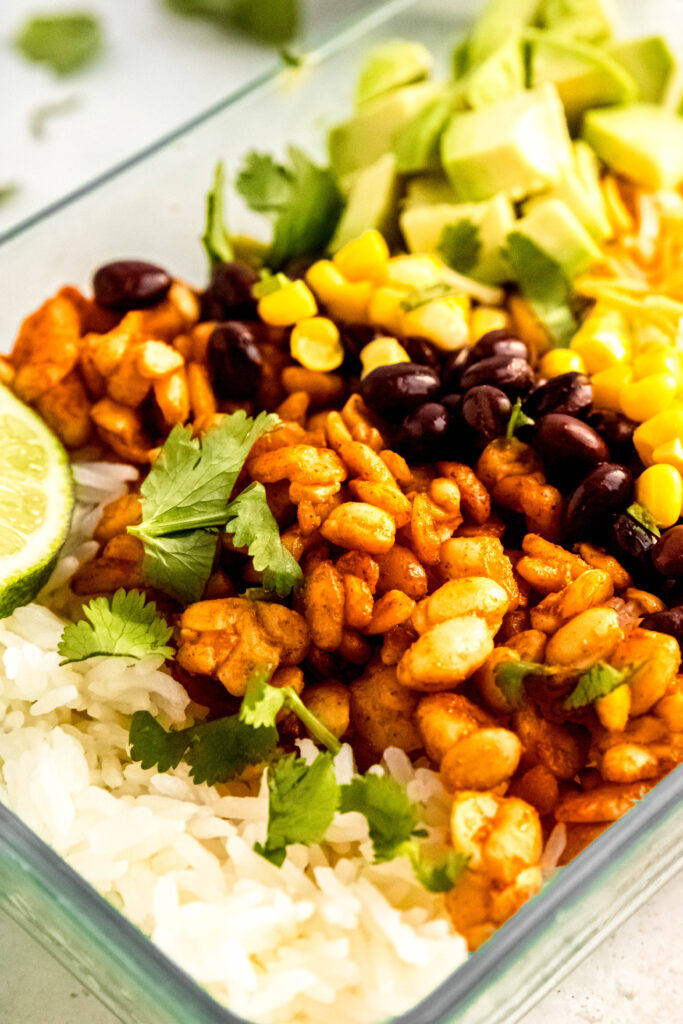 Tempeh burrito bowl close up in meal prep storage container