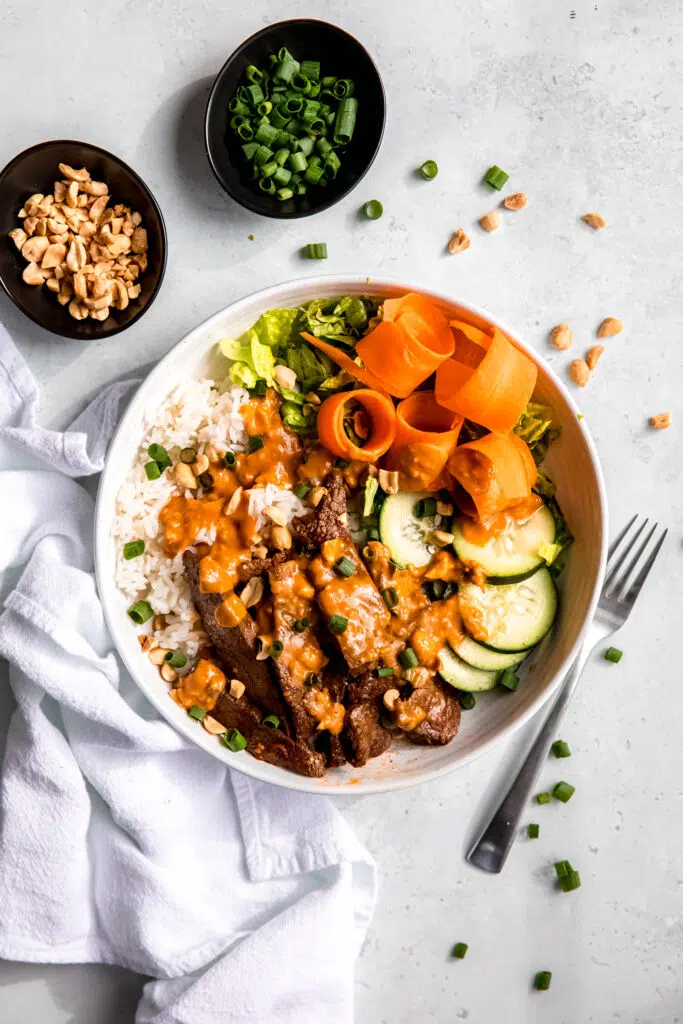 Bulgogi bowls with flank steak and peanut sauce on top