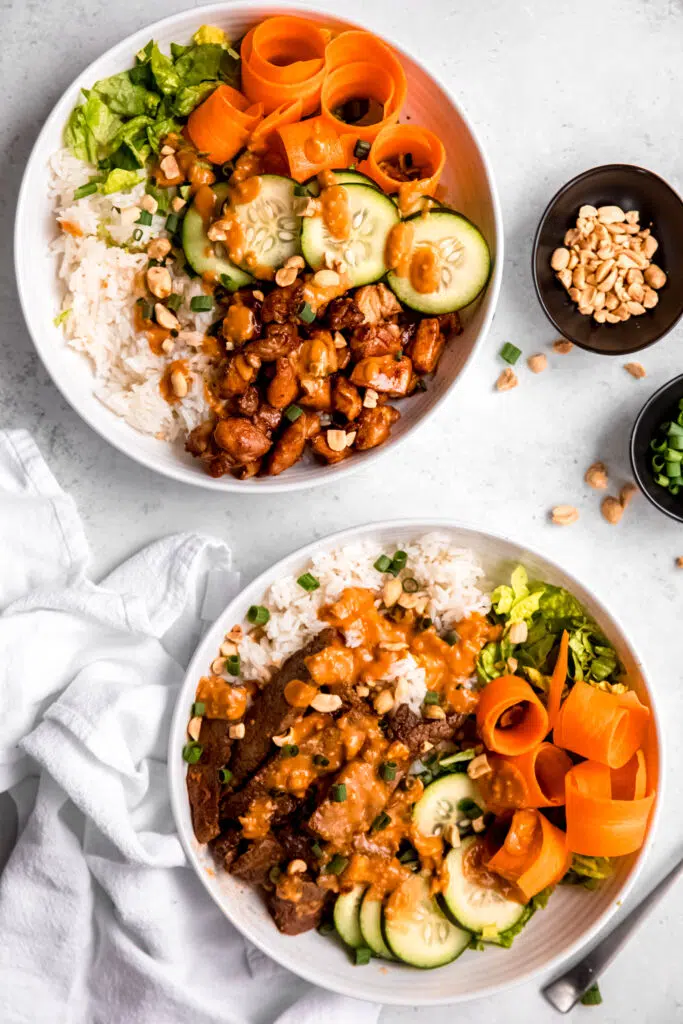 Two Bulgogi-Inspired Bowl with Gochujang Peanut Sauce and peanuts in background