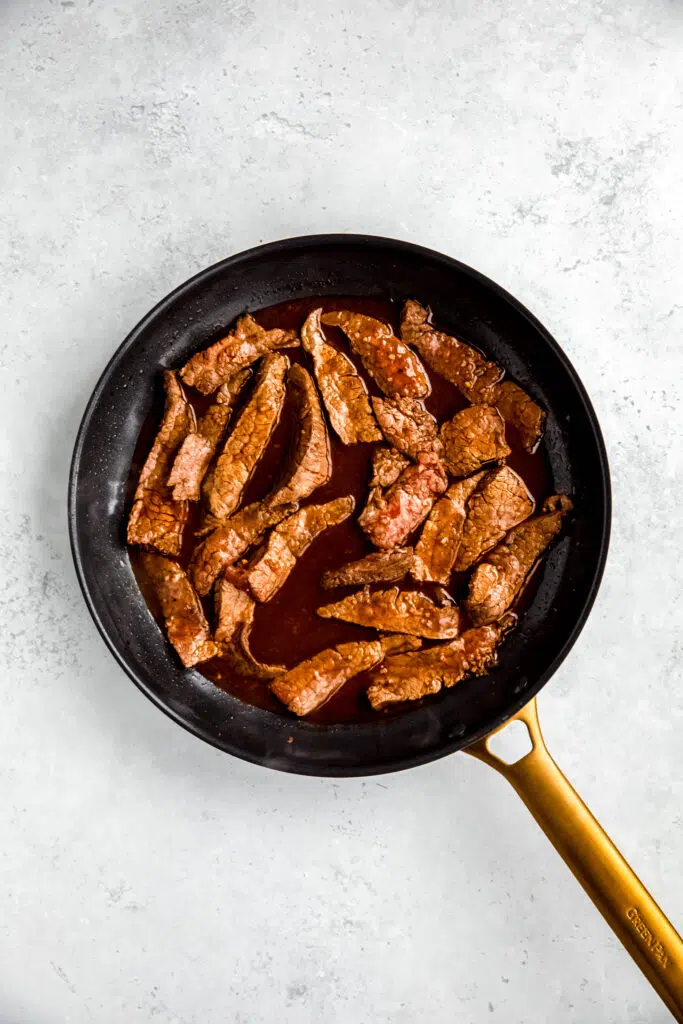 Steak cooking in saute pan