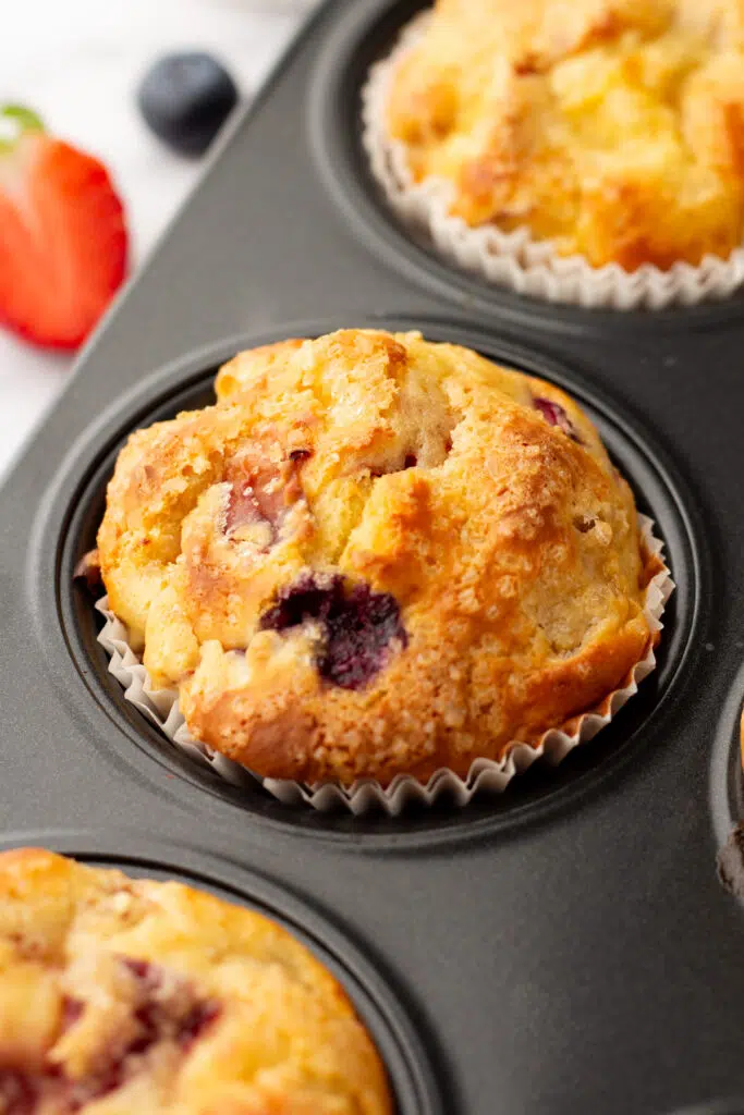 Close up of cooked blueberry protein muffin in pan.