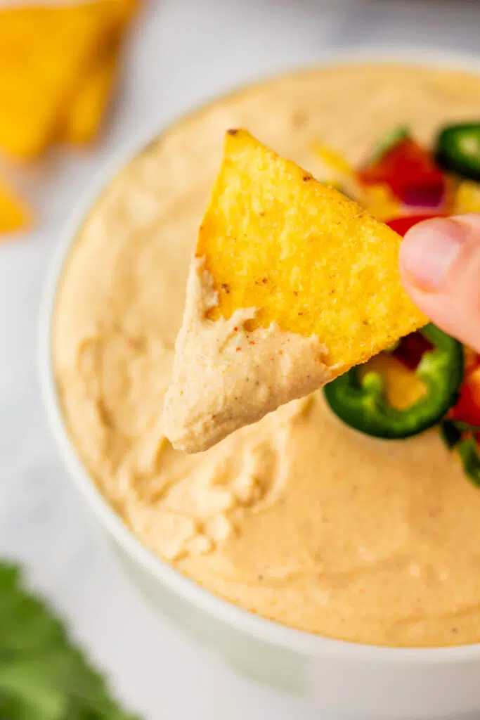 Chip dipped in cottage cheese queso dip