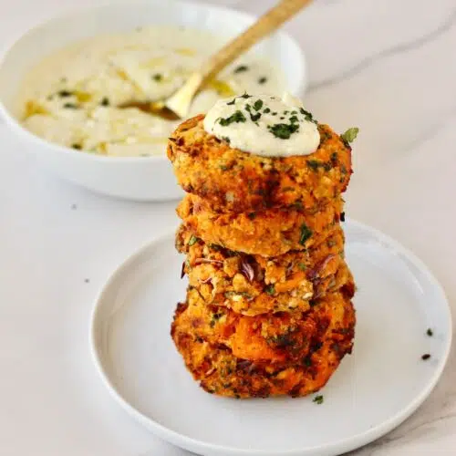 Stack of sweet potato patties with feta dip