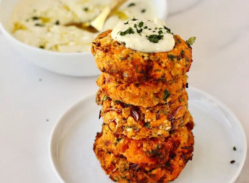 Stack of sweet potato patties with feta dip