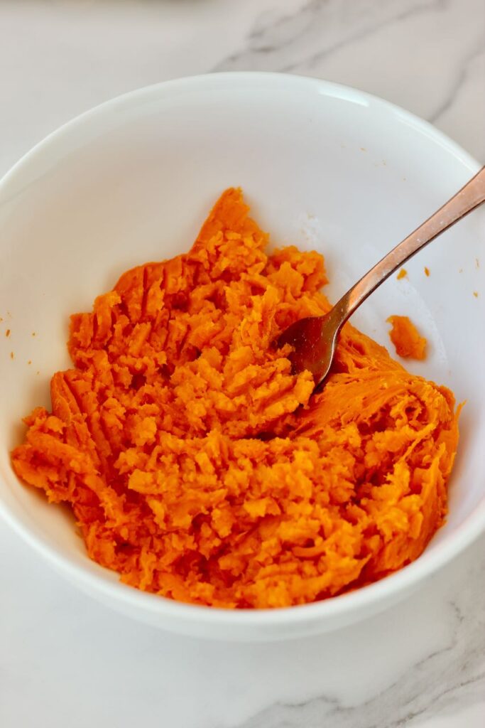 Sweet potato mashed in white bowl