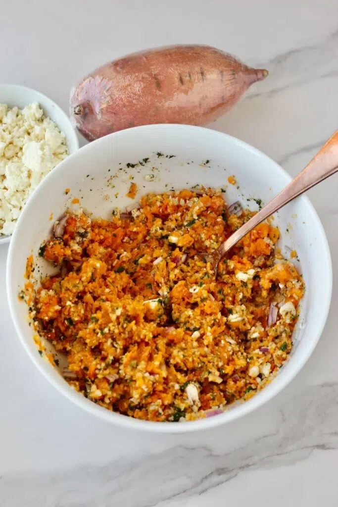 sweet potato patty ingredients mixed together in white bowl