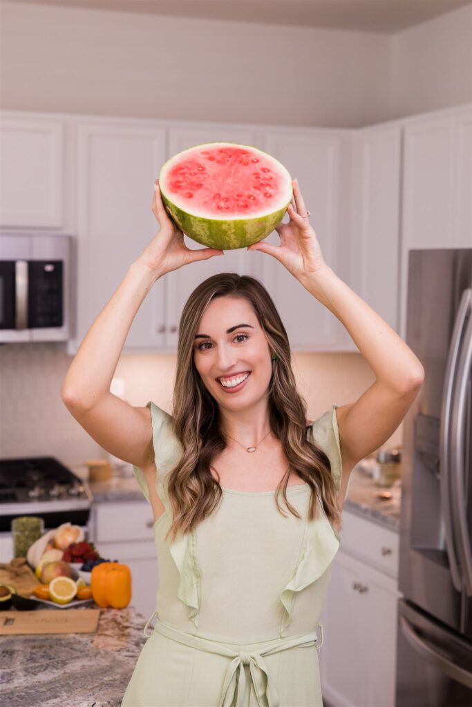 Mackenzie holding watermelon over head