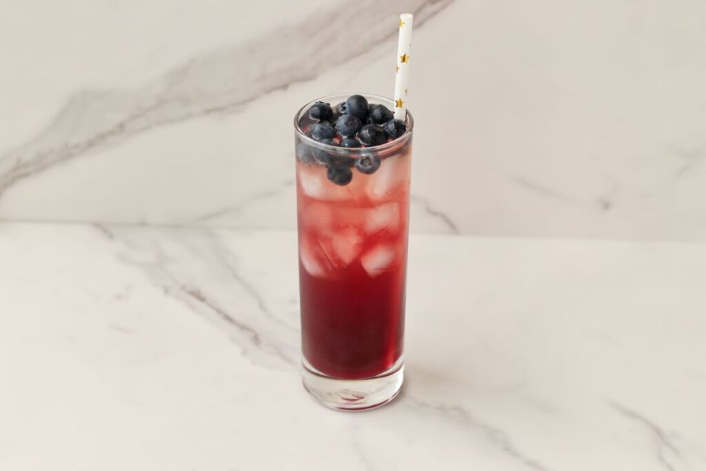 DIY electrolyte cooler with blueberries and star straw