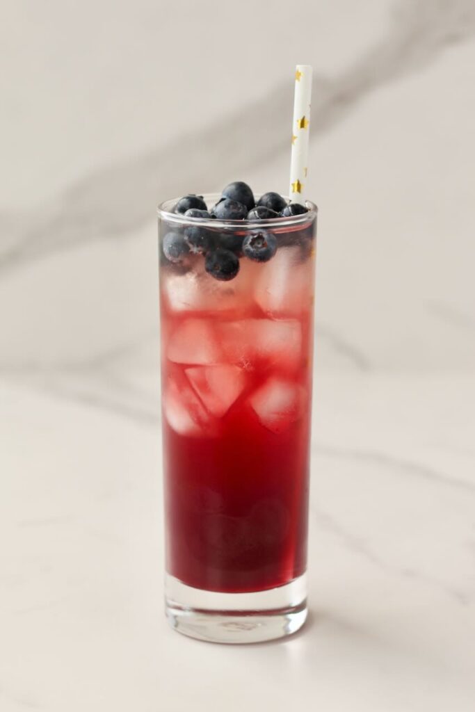 DIY electrolyte cooler with blueberries and star straw