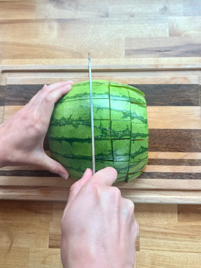 Cutting perpendicular to lengthwise cuts, forming 2x2 rectangular pieces