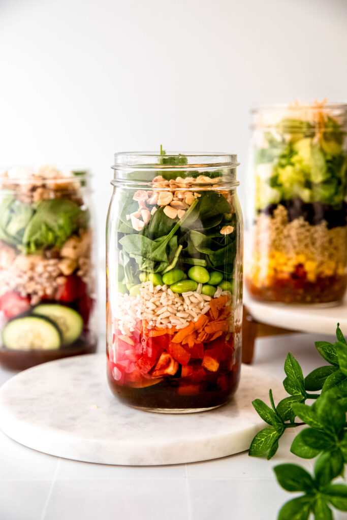Mason jar with peanut toppings added on top of everything