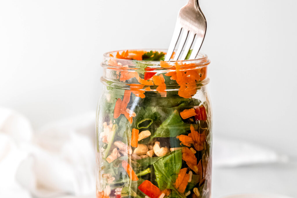 Fork going into mason jar salad