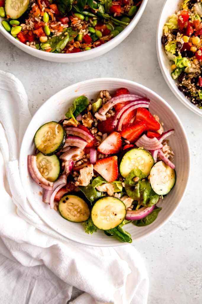 Berry salad in white bowl and white napkin