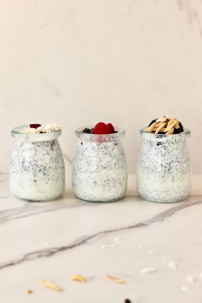 Side view of 3 types of chia pudding in jars with different toppings