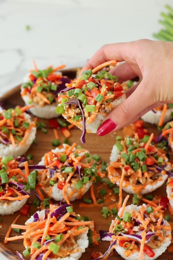 Hand holding Korean BBQ chicken rice cup