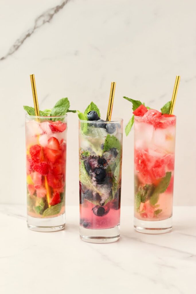 Customizable fruit mojitos done 3 ways with gold straw - strawberry, blueberry, watermelon 