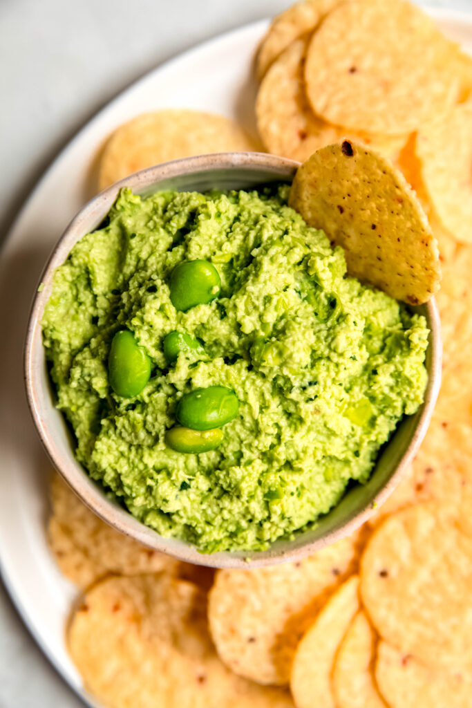 Edamame guac in bowl with tortilla chips