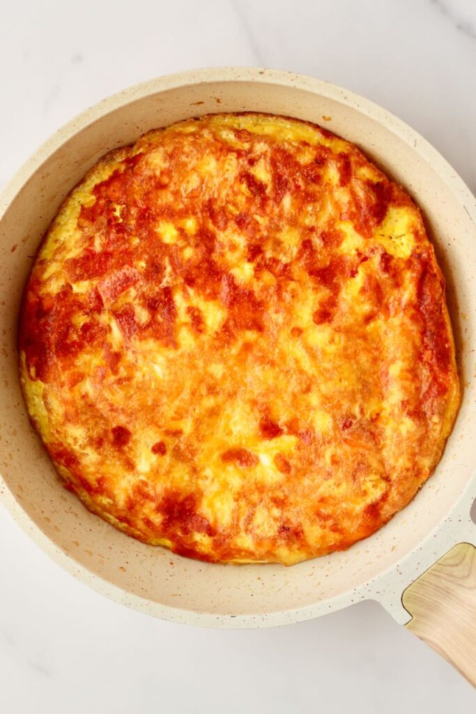 Golden egg pizza in skillet
