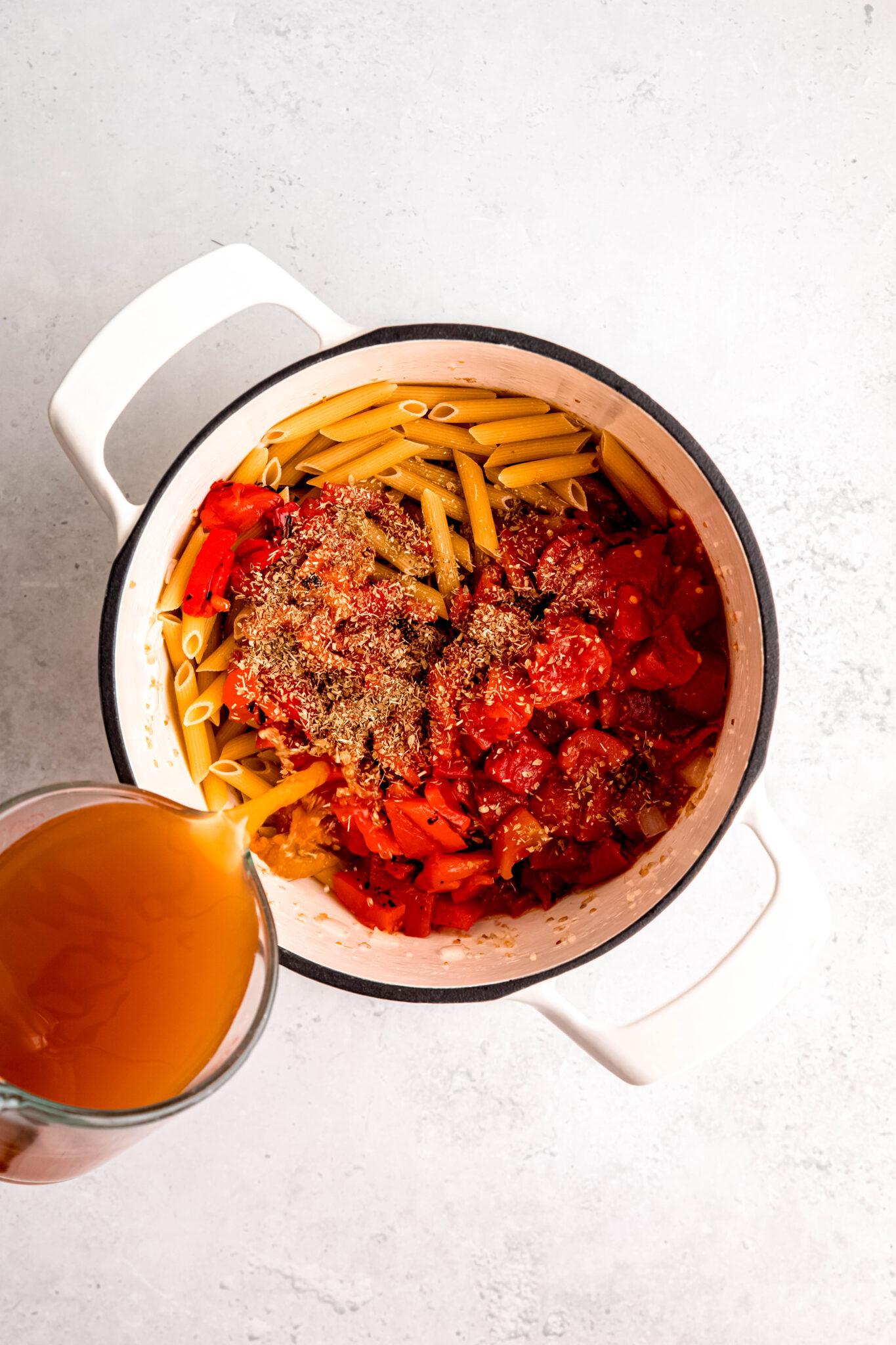Pouring bone broth in pasta
