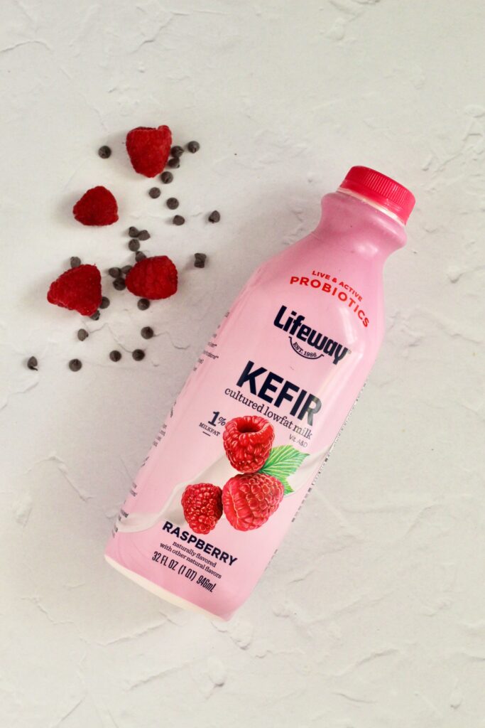 Raspberry Lifeway Kefir in bottle with chocolate chips and raspberries in background