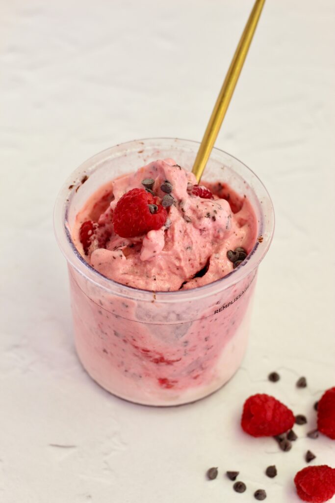 Raspberry Dark Chocolate Lifeway Kefir Protein Ice Cream in pint with gold spoon