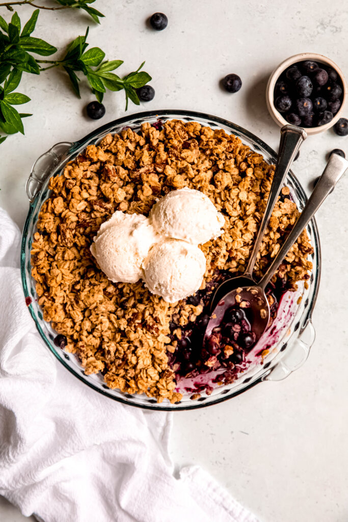 Customizable Fruit Crisp with blueberries on side and white towel.