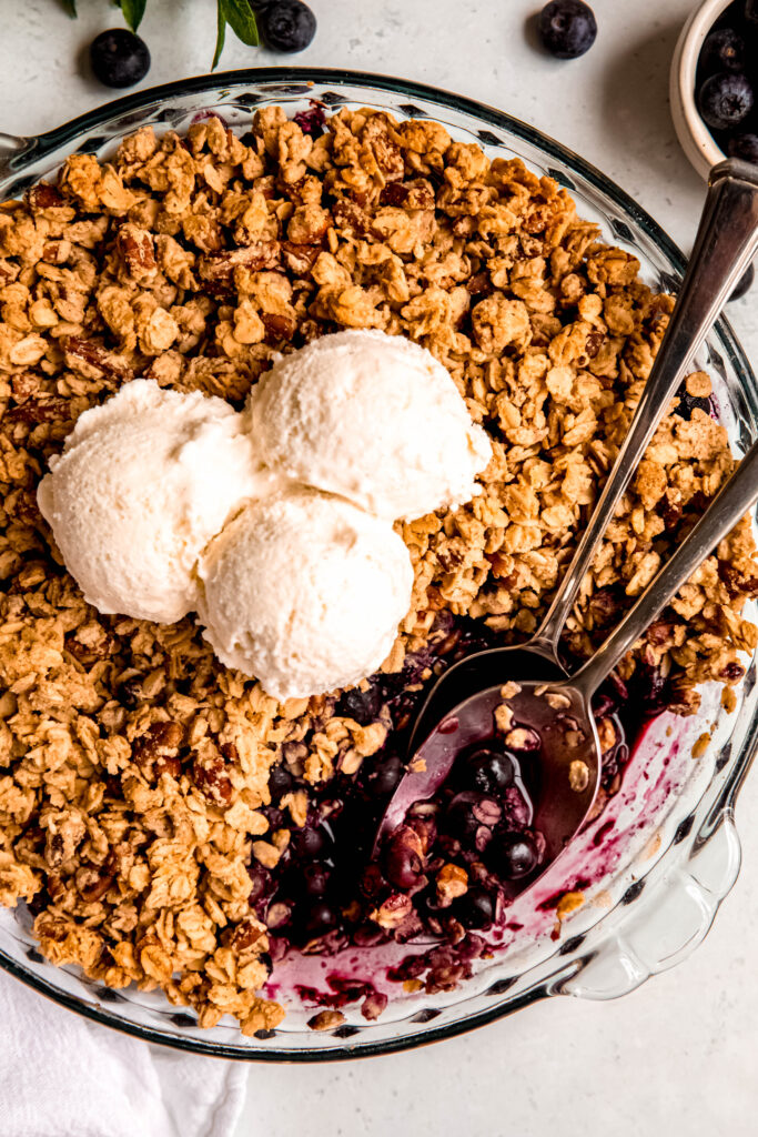 Customizable Fruit Crisp with spoons with blueberries on it.