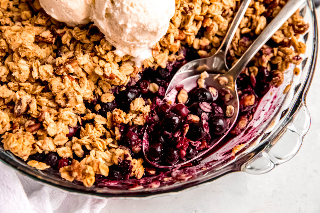 Customizable Fruit Crisp with spoons with blueberries on it.