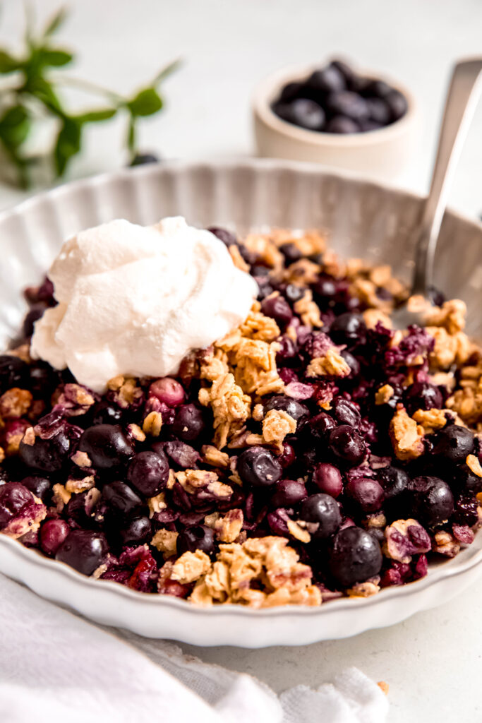 Customizable Fruit Crisp topped with yogurt in white bowl