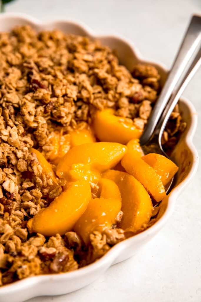 Customizable Fruit Crisp with spoons with peaches on it.