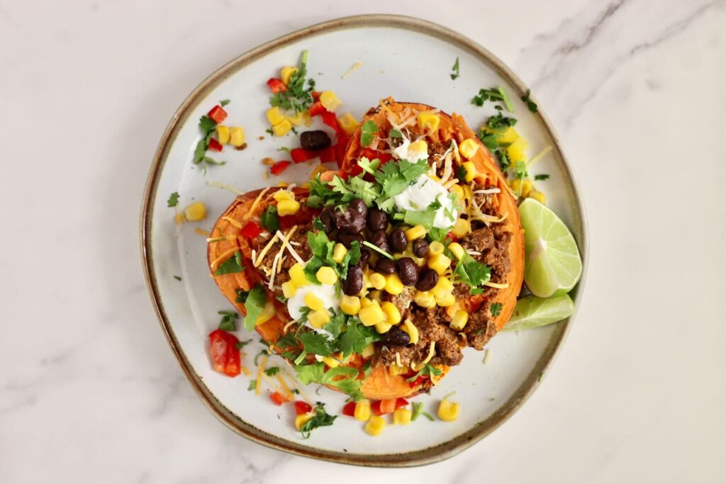 Stuffed Sweet Potato on white plate with toppings of choice