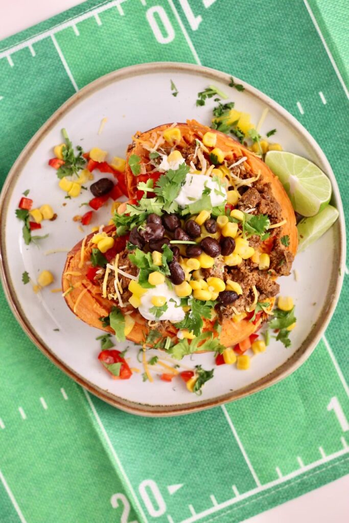 Stuffed Sweet Potato with toppings of choice on green "football field" mat