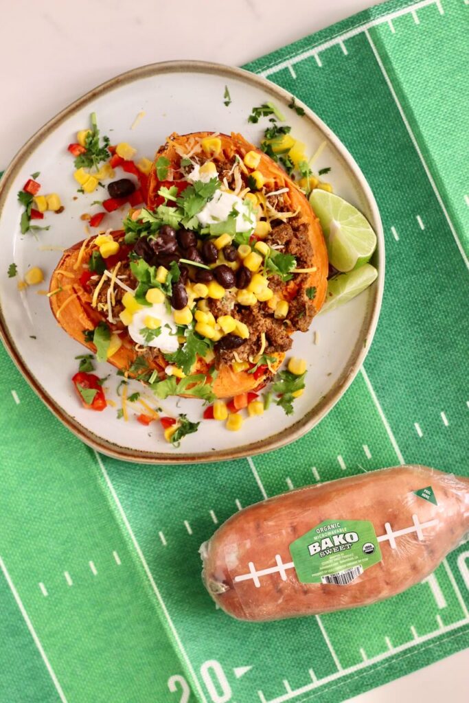 Stuffed Sweet Potato with uncooked Bako sweet potato on side on green "football field" mat