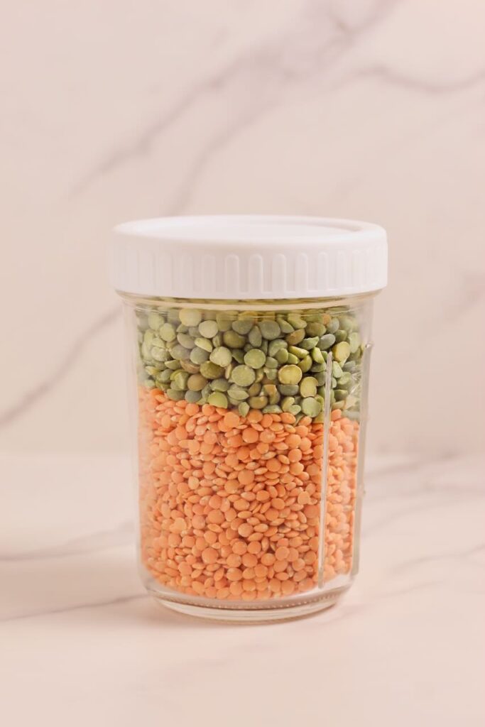 Red lentils and split peas in mason jar with white lid